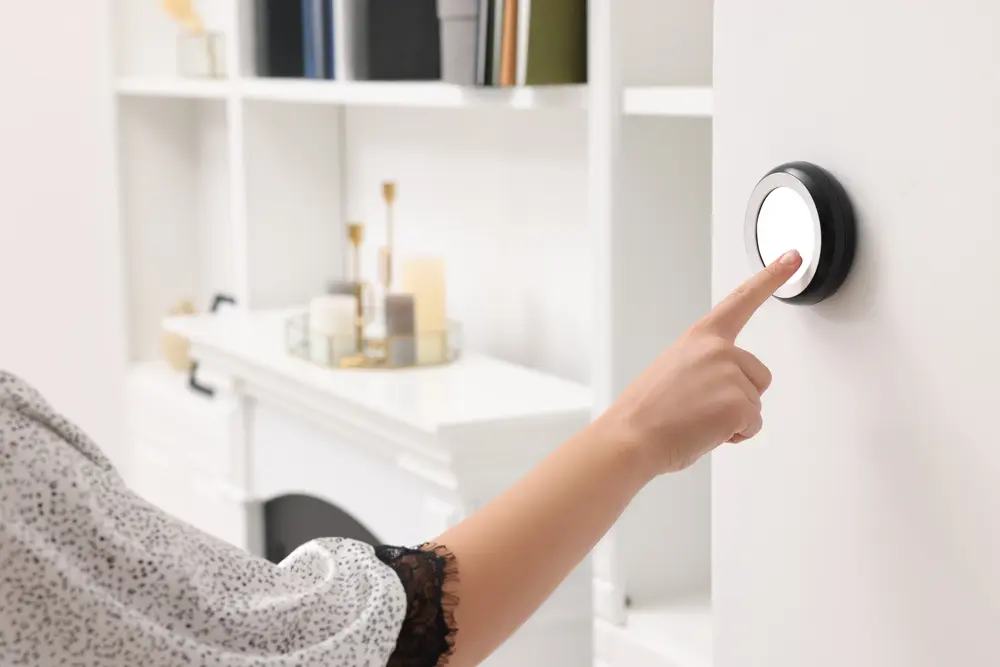 Woman adjusting smart thermostat